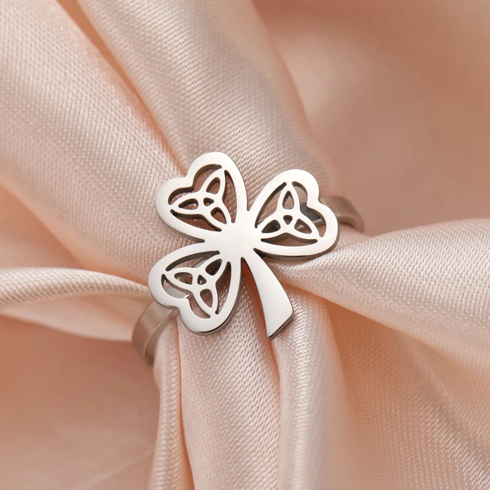 Women's stainless steel lucky hollow ring in gold colour on a hand, showing hollow band construction.