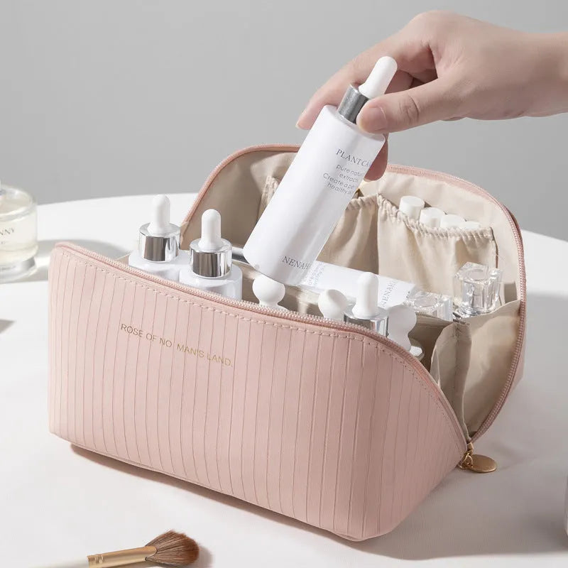 Vertical pattern pillow-shaped cubic makeup bag in PU material, shown in a neutral colour.