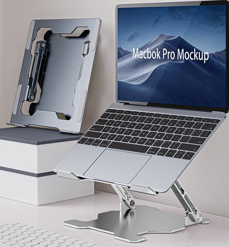 Grey aluminium laptop stand with adjustable angle, folded flat next to a laptop.