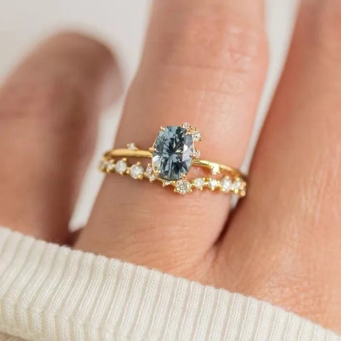 Gold-plated women's ring with green zircon stone in floral design on finger