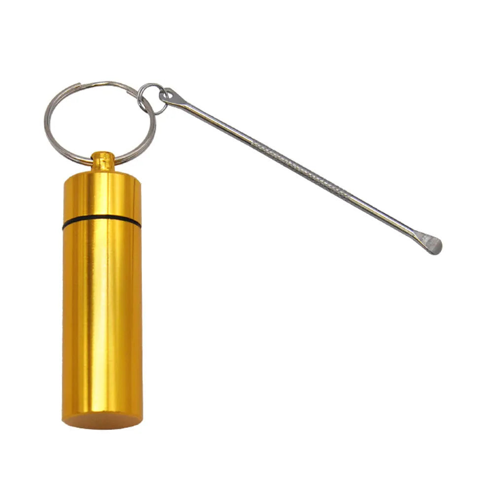Blue aluminium portable pill storage bottle with an integrated spoon and a silver keychain ring attached.