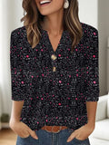 Woman wearing a loose grey V-neck top with a white 3D-effect geometric pattern print.