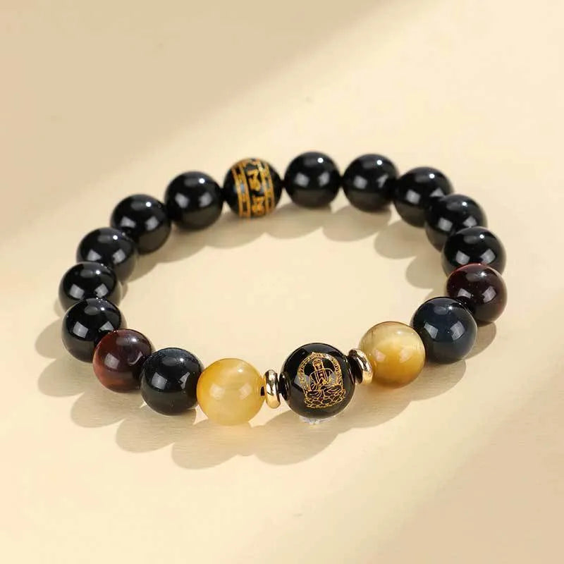 Handmade black agate beaded bracelet with gold, blue, and red tiger eye stones featuring Buddhist deity and zodiac animal motifs.