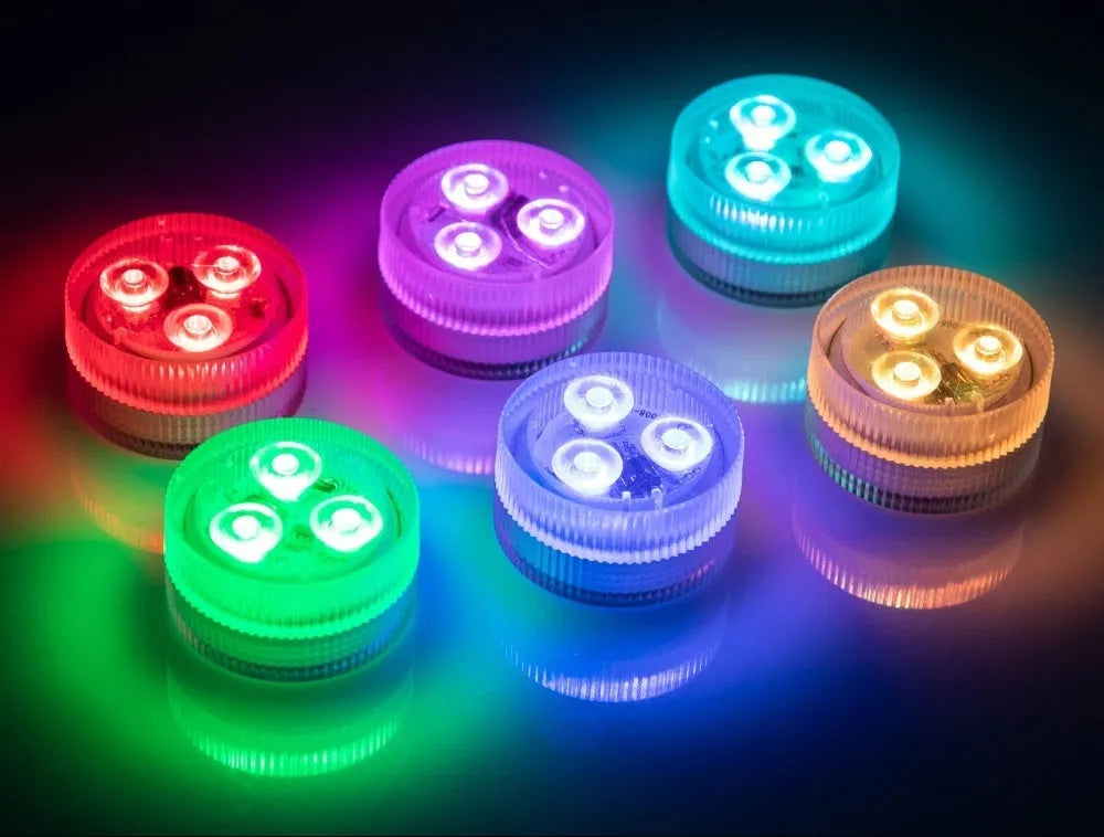 Small round submersible LED aquarium light with remote control on a white background