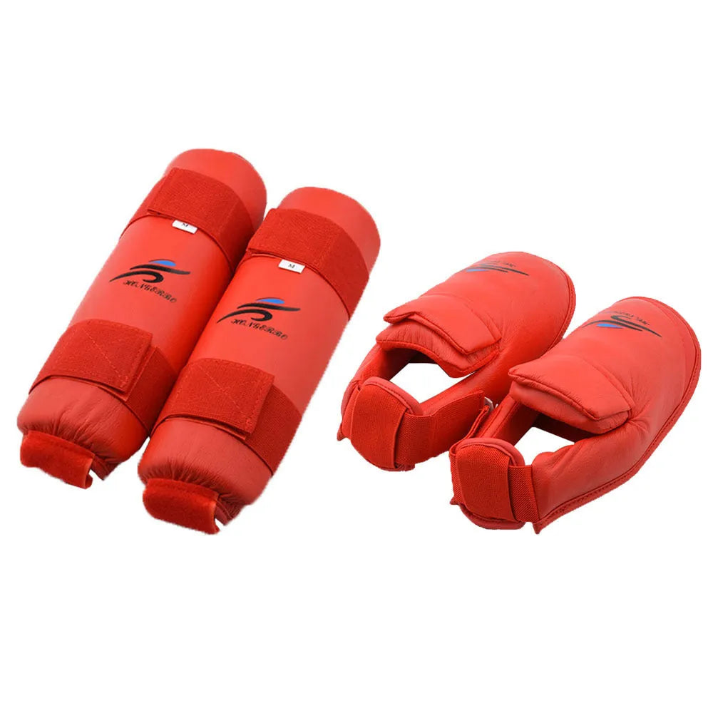 Red and blue karate protective gear set with helmet, boxing gloves and leg guards on training mat
