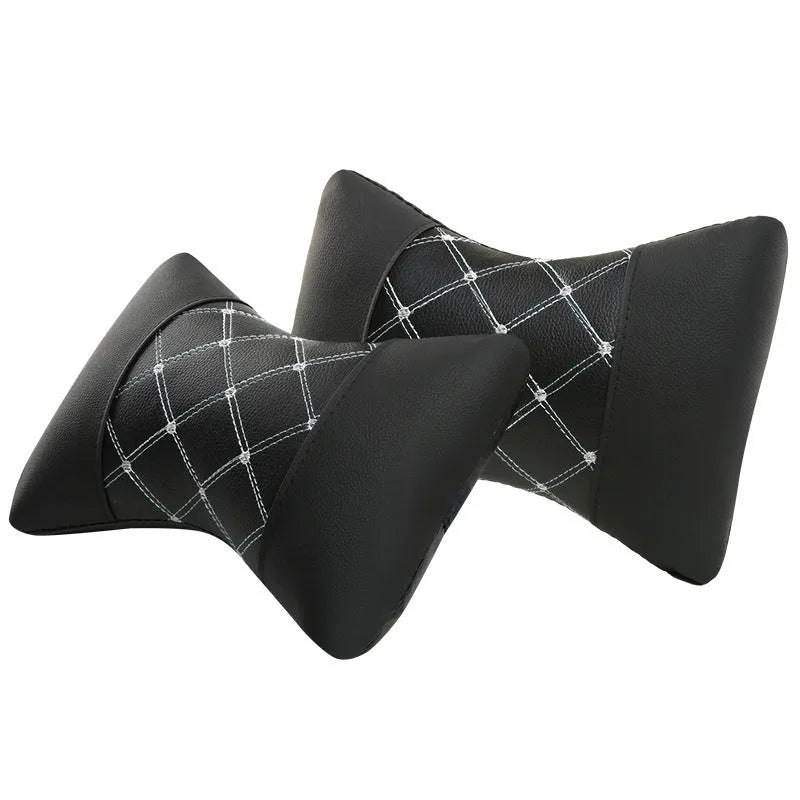 Black artificial leather car headrest pillow with quilted diamond pattern and coloured stitching.