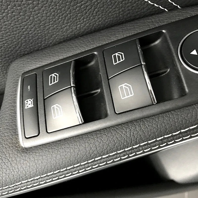 Black ABS plastic decorative sticker for car window lift button on door panel.