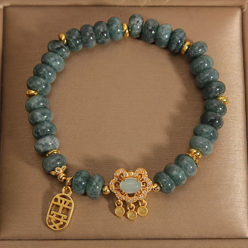Women's bracelet with green jade abacus beads and a metallic safety lock clasp.