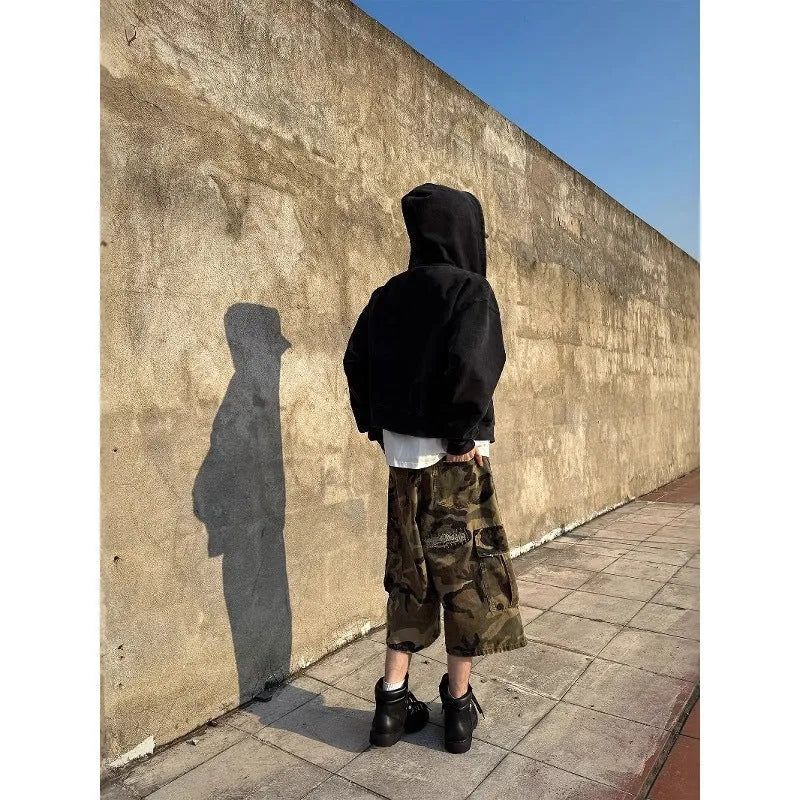 Men's loose-fit camouflage cropped jeans with ripped and patch details on a straight-leg.