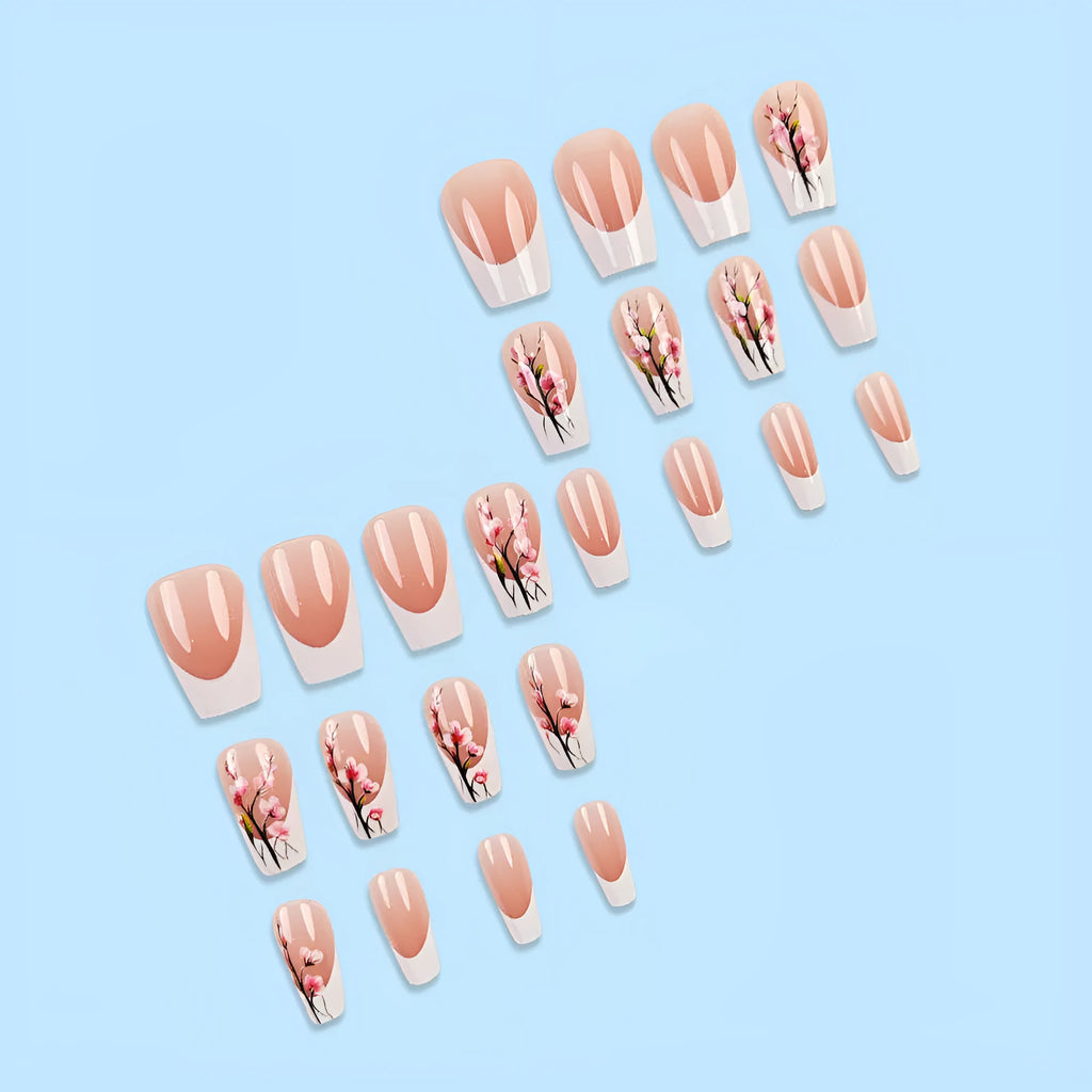 Plum blossom style nail tips with simple white edge French design and starry sky pattern on a table