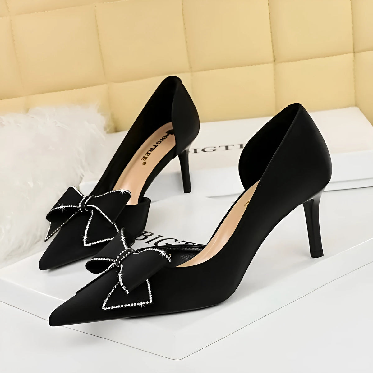 Women's black satin stiletto heel pump with rhinestone bow and side hollow cut-out