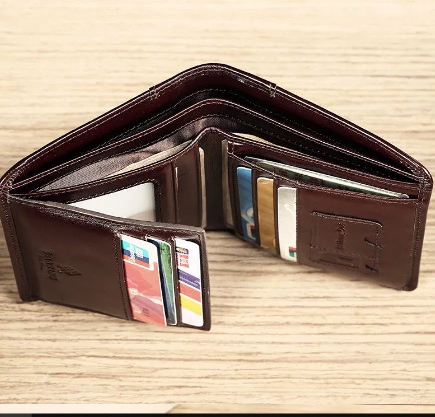 Men's black genuine leather bi-fold wallet open, showing eight card slots, a note compartment, and a zipped coin pouch.
