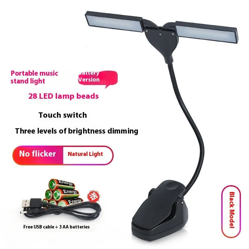 Black clip-on music stand lamp with 28 LEDs, shown with USB cable and AA batteries.