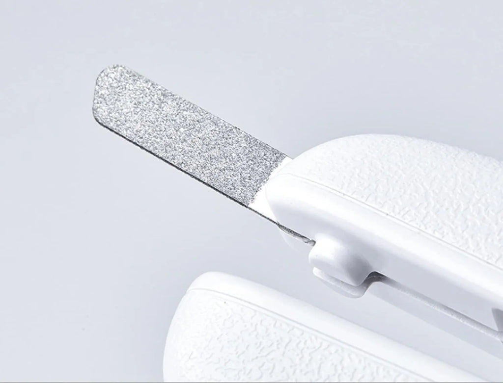 White pet nail clippers with LED light, transparent anti-splash guard, and triangular blade for cats and dogs