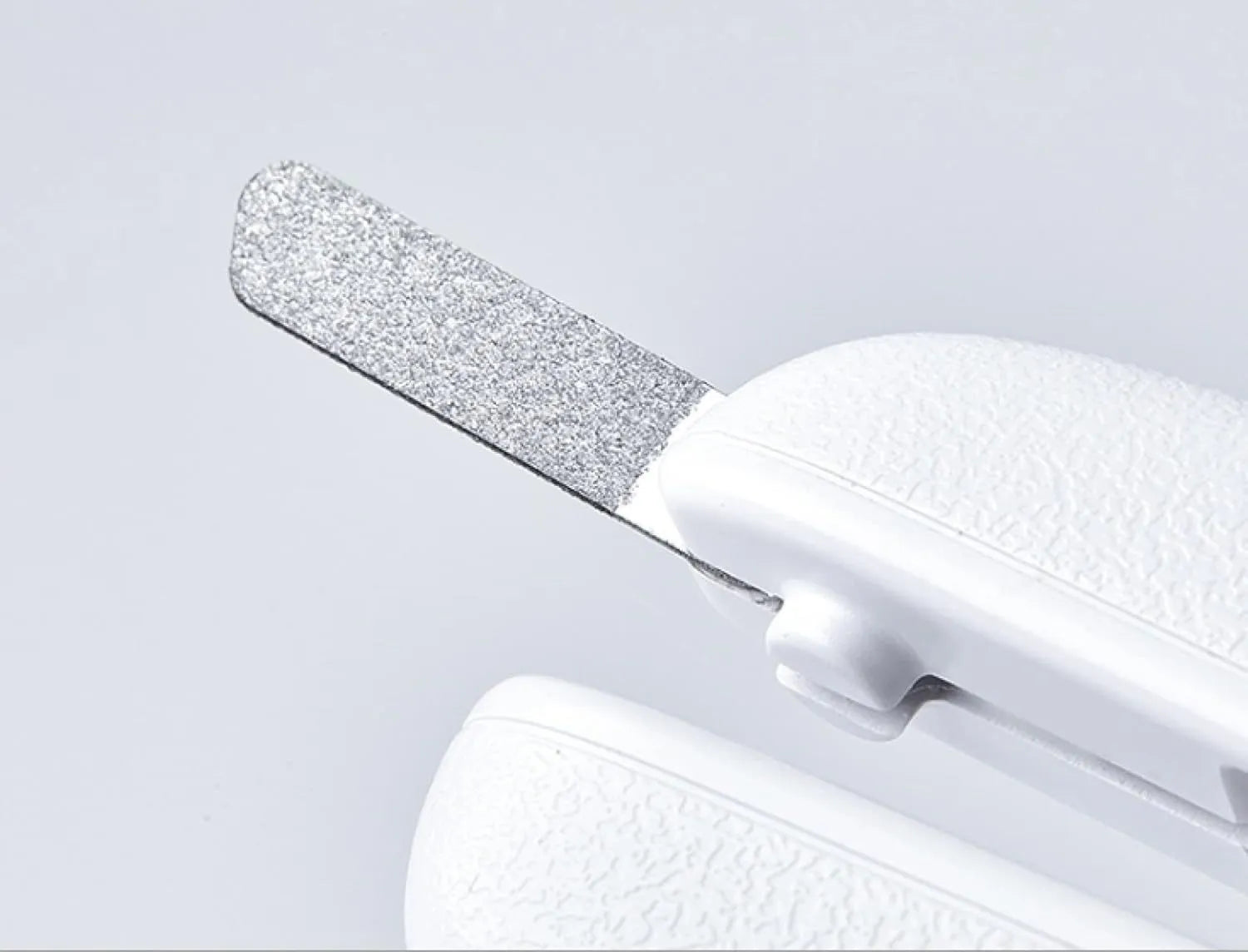 White pet nail clippers with LED light, transparent anti-splash guard, and triangular blade for cats and dogs
