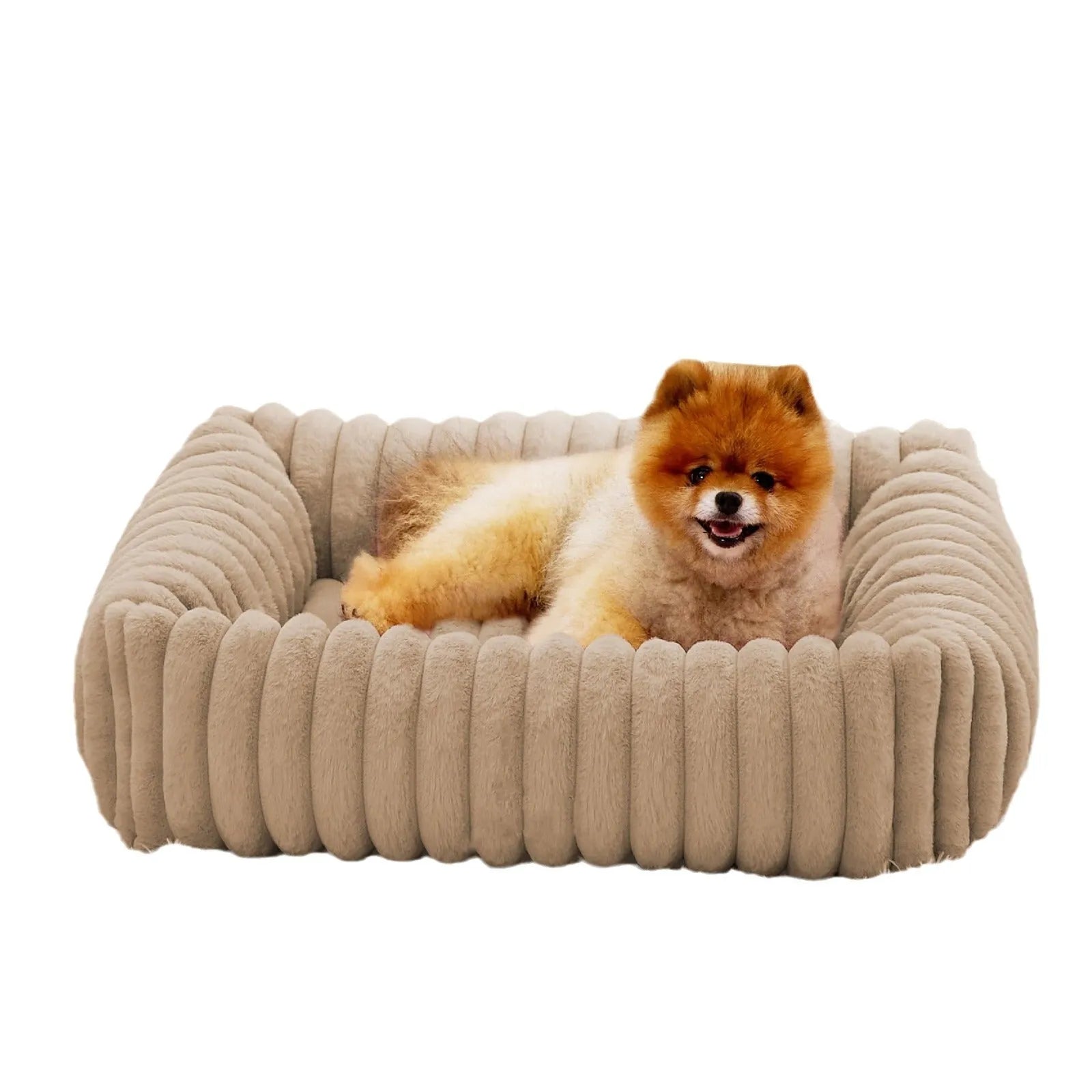Beige plush pet bed with raised bolster sides for cats and dogs, shown in a home setting.
