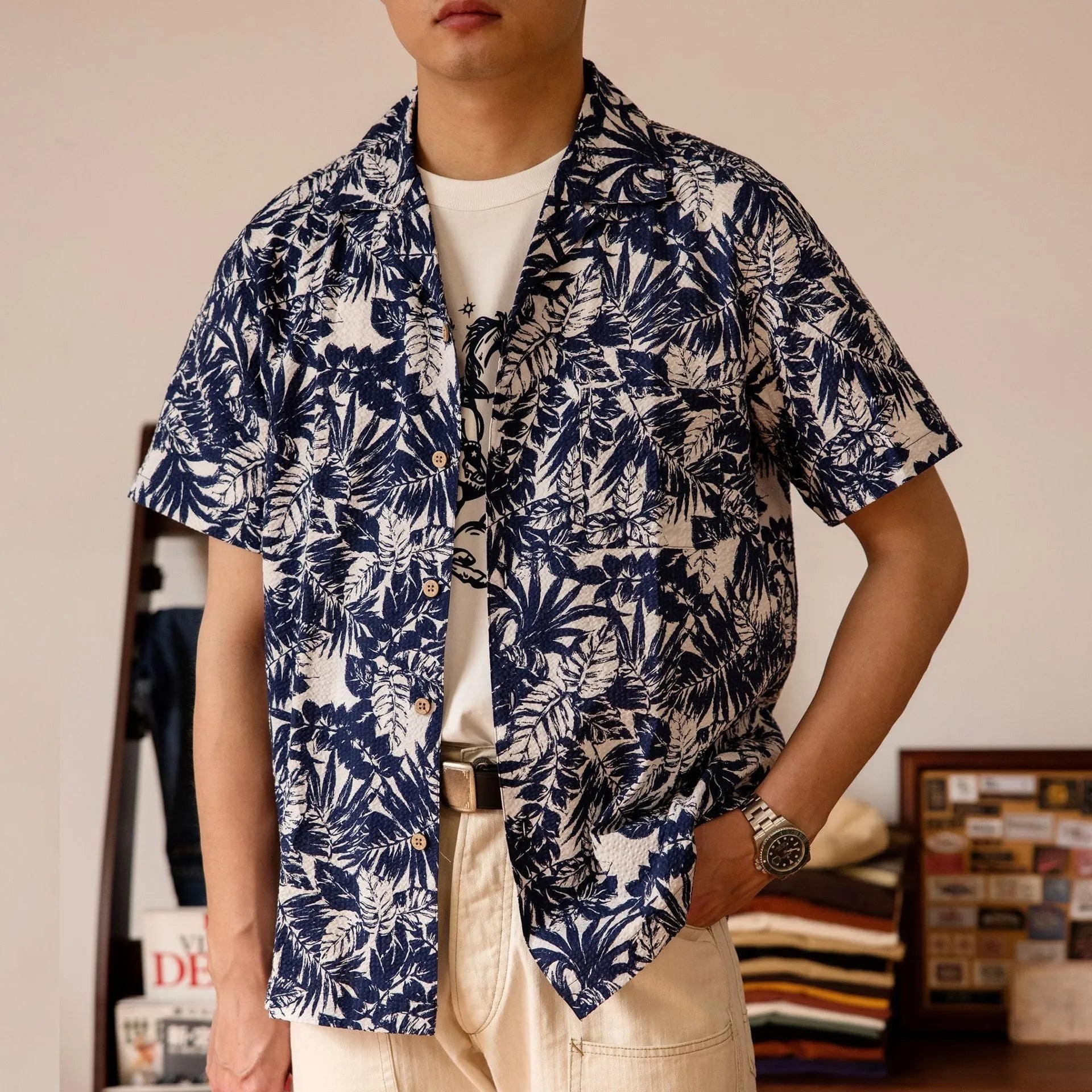 Man wearing a vintage floral print seersucker shirt with a Cuban collar in a loose, casual fit.