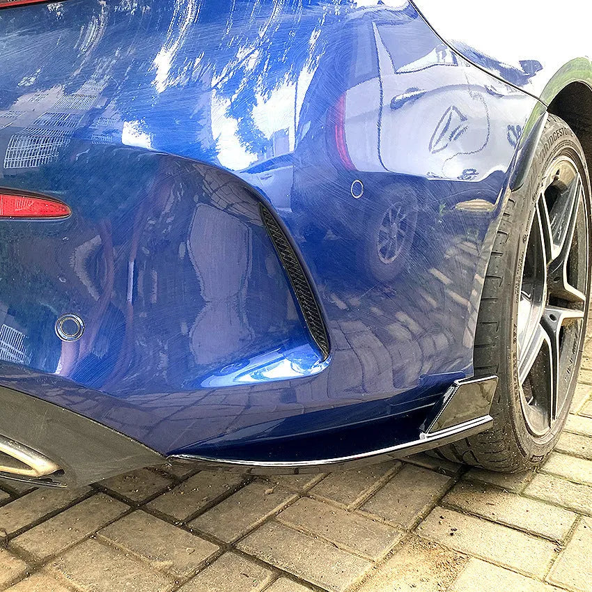 PP plastic car rear corner protectors in piano black and carbon fibre pattern finishes shown as a left and right set