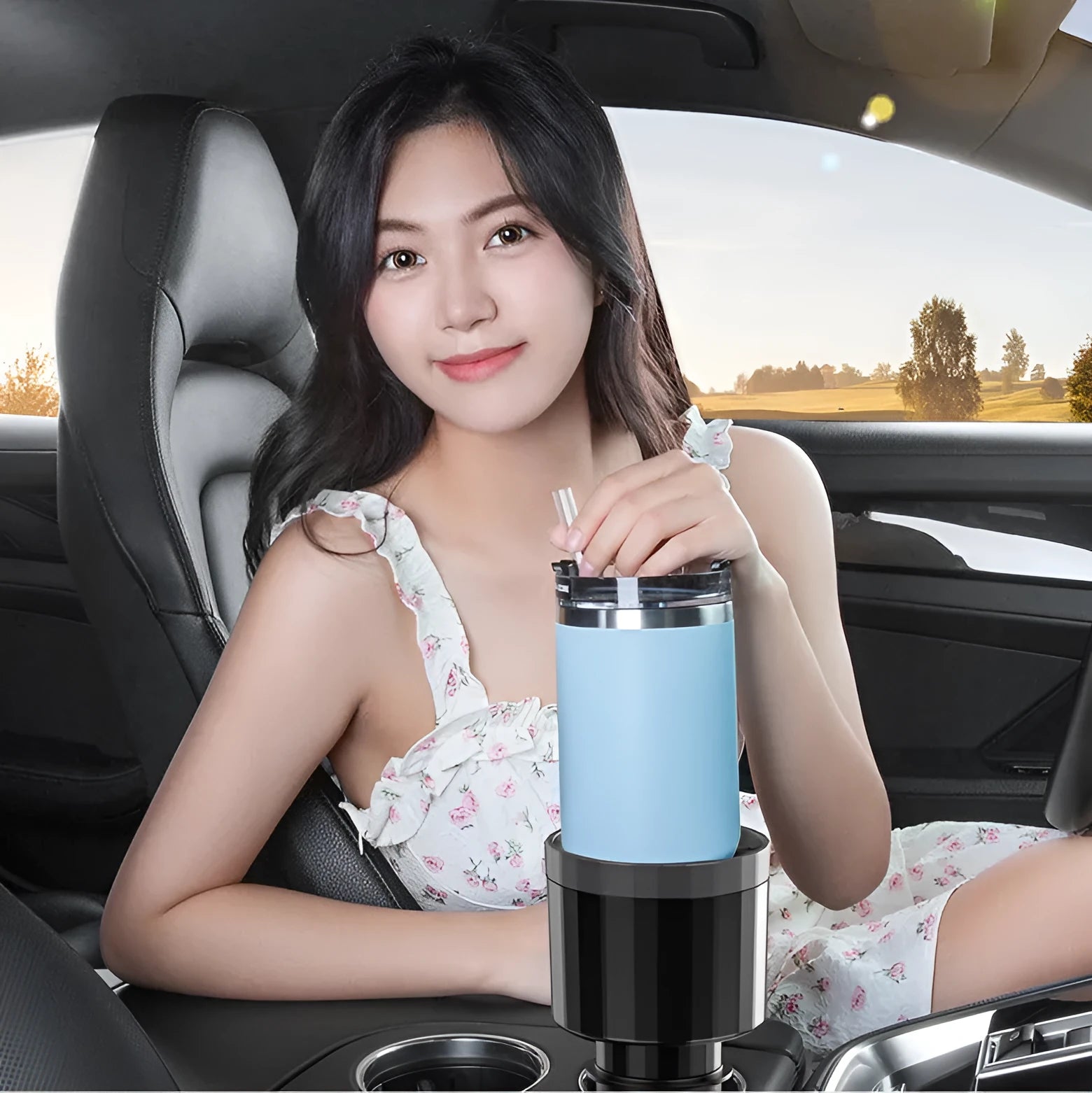 Matte black adjustable car cup holder expander for large bottles installed in a centre console.