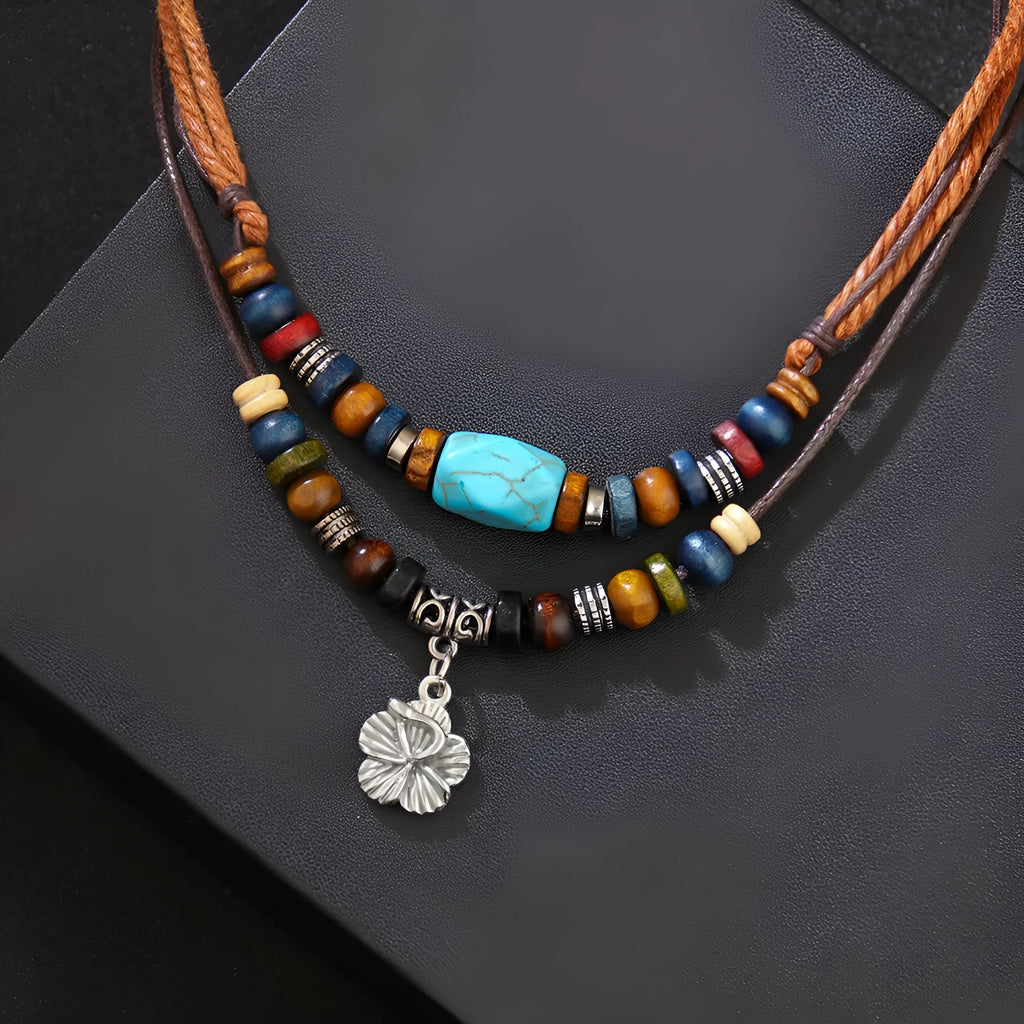 Turquoise wooden bead necklace with alloy geometric flower pendant on brown wax rope cord