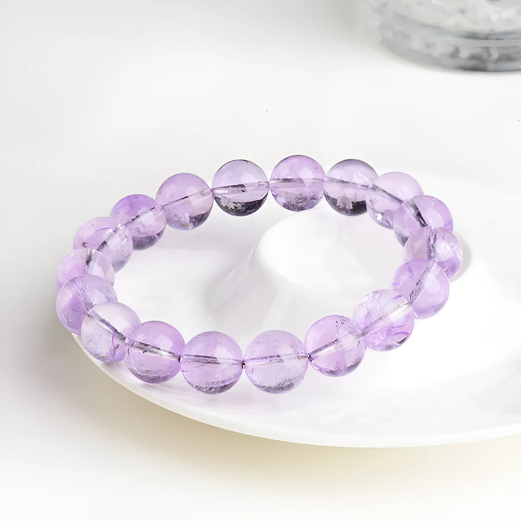 Lavender amethyst crystal bracelet with round beads showing light purple colour and water ripple design.