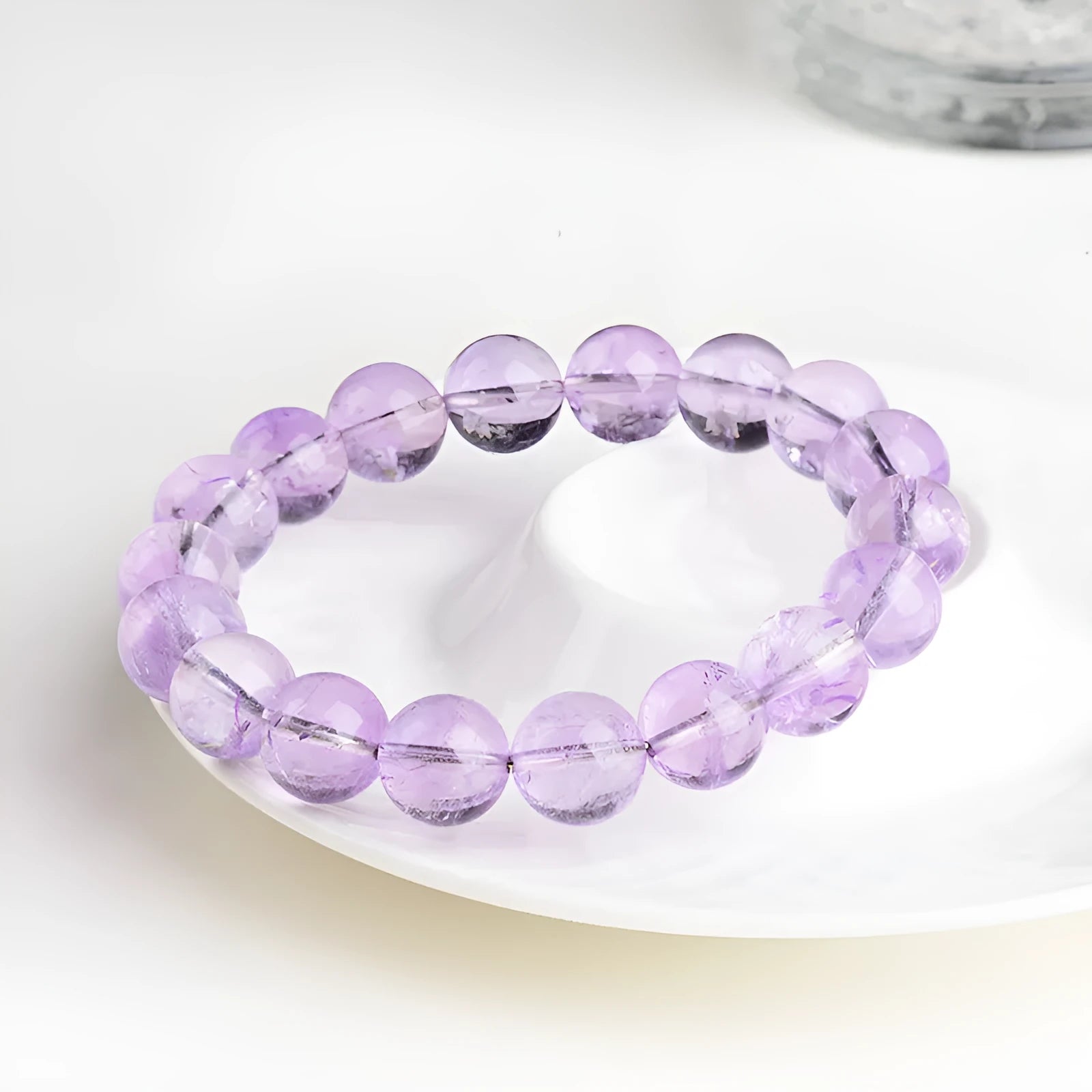 Lavender amethyst crystal bracelet with round beads showing light purple colour and water ripple design.