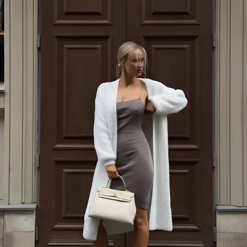 White oversized knitted cardigan jacket with long sleeves on a model.