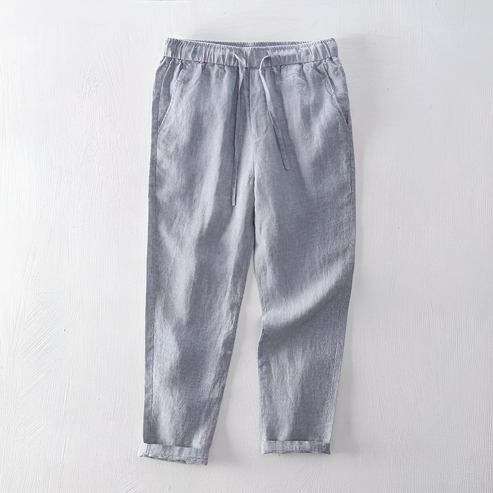 Men's straight leg linen trousers in light grey colour showing mid waist and relaxed fit