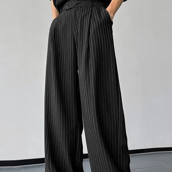 Black men's casual trousers with vertical stripes and front pleats on a hanger.