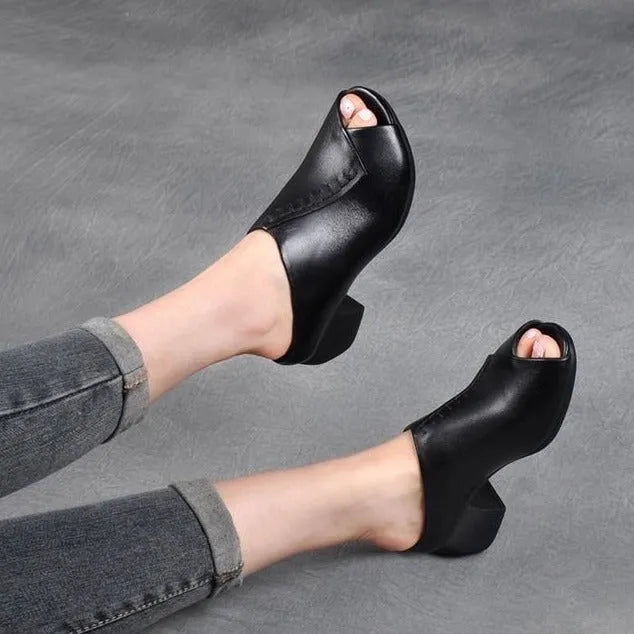 Women's black square heel peep-toe slippers with a fish mouth scaffold design on a rubber sole.