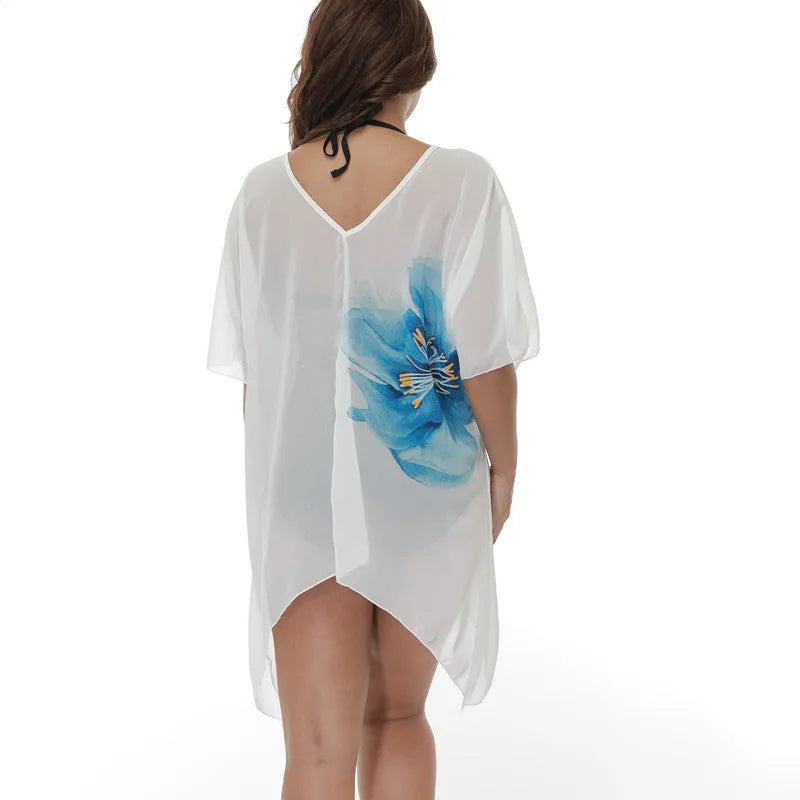 White plus-size loose beach cover-up blouse for women on a hanger.