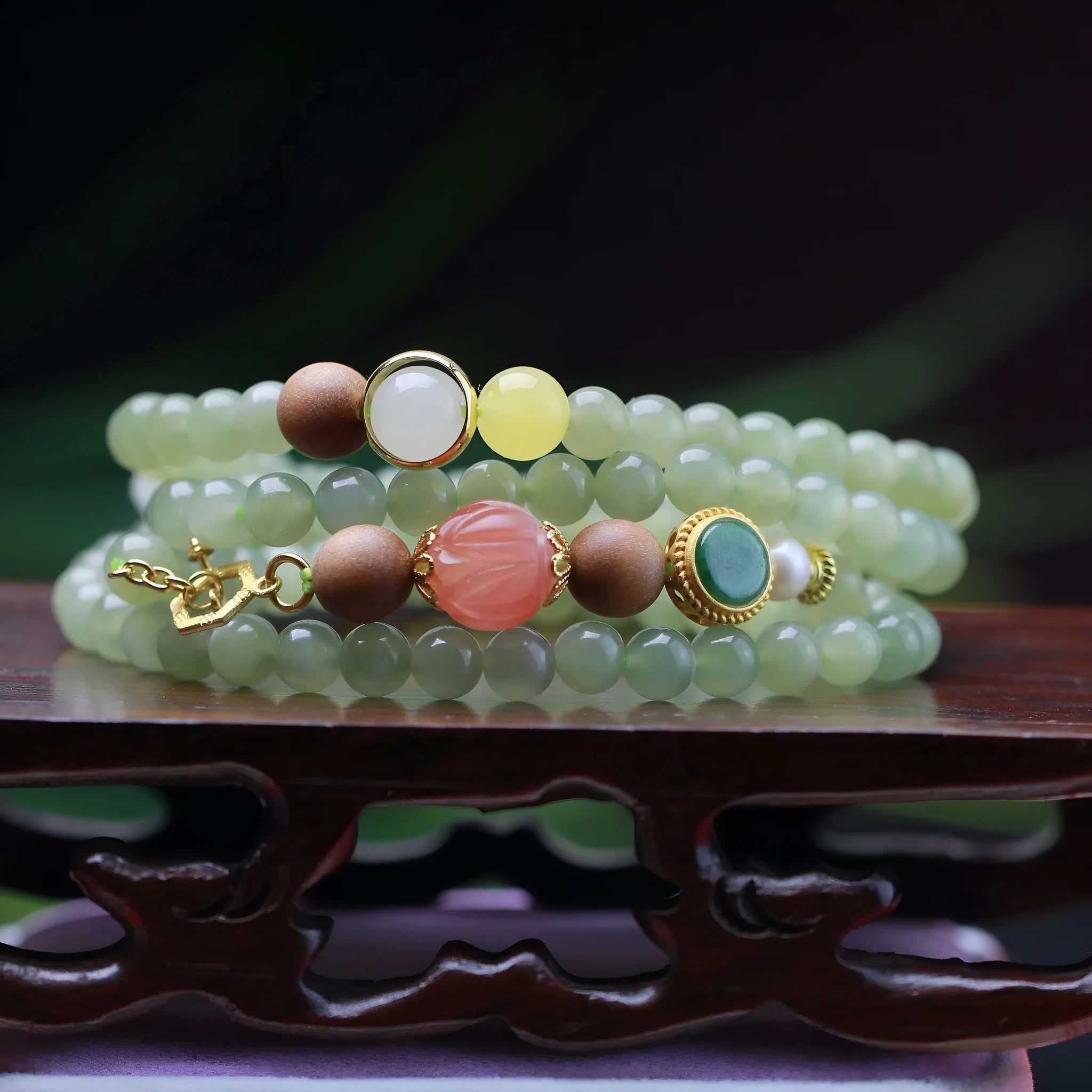 Handmade Hetian jade and white sandalwood necklace with red lotus beads and fu charm, shown with matching bracelet.