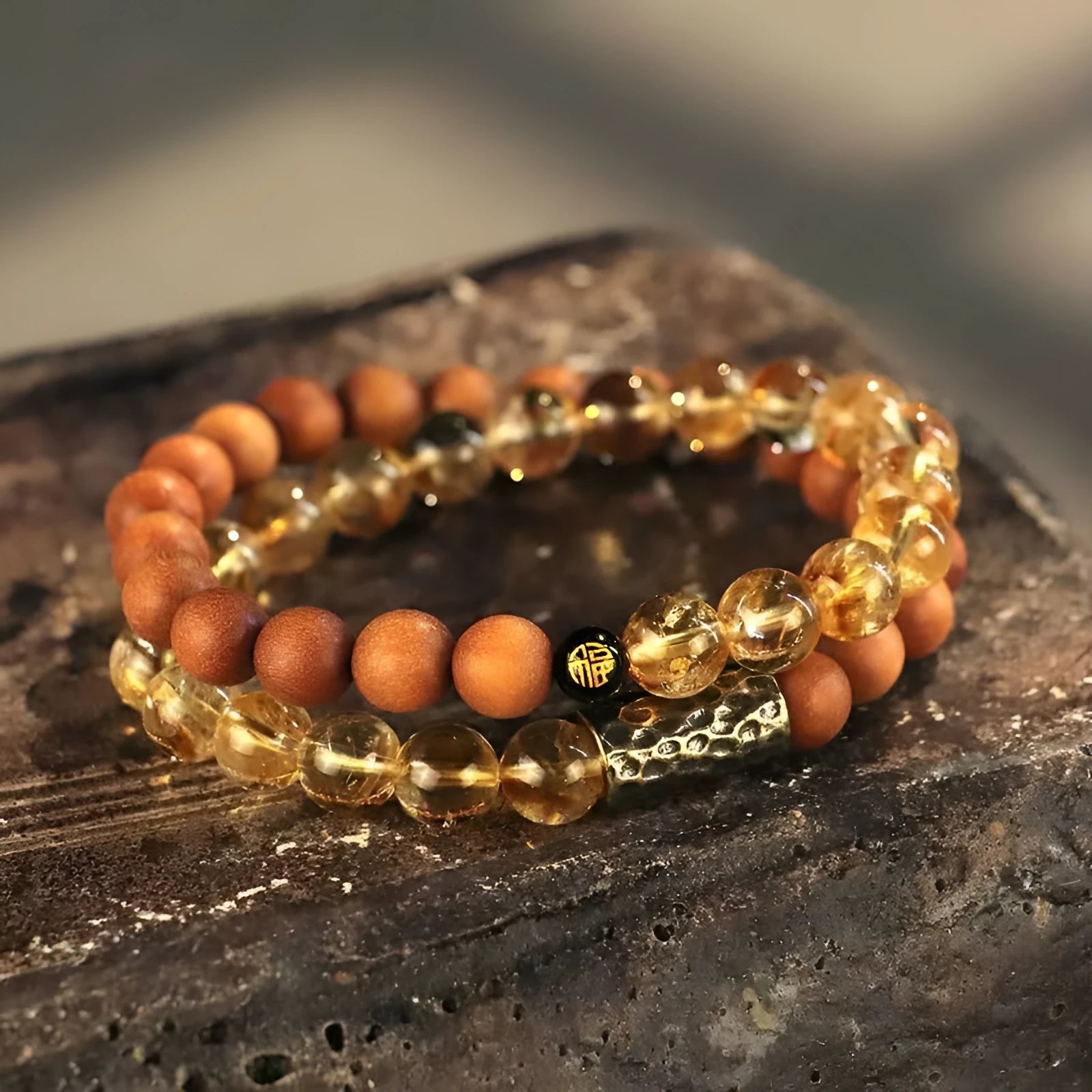 Handmade yellow tower crystal bracelet with double ring design on wrist.