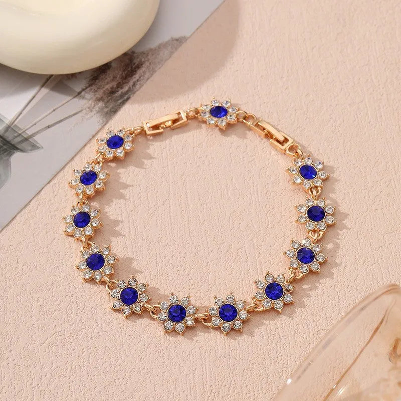 Coloured gemstone bracelet with flower-shaped design in gold and silver colour variations