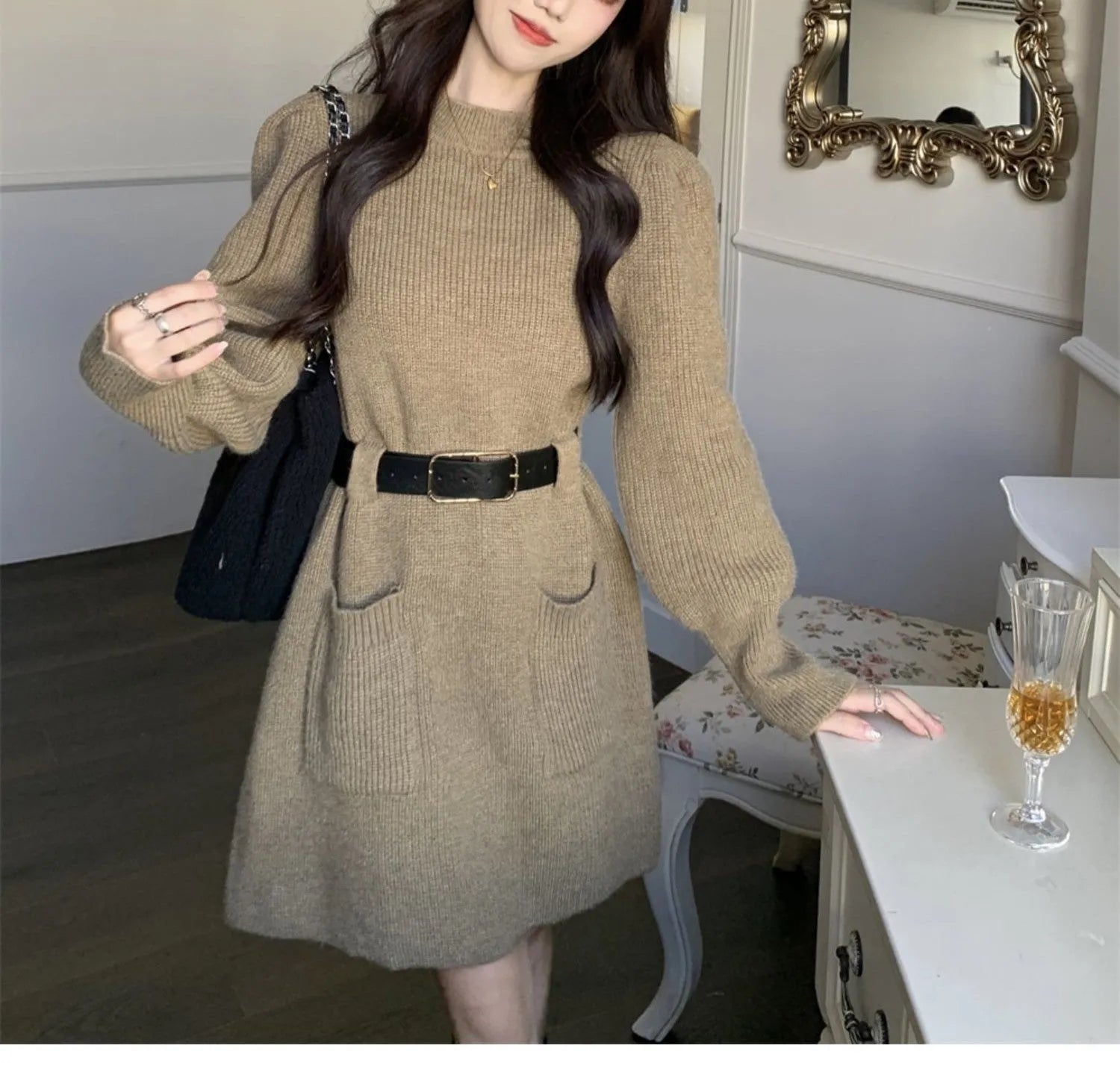 Women's loose-fitting, high-waist knitted dress with long sleeves in beige colour with a black belt.