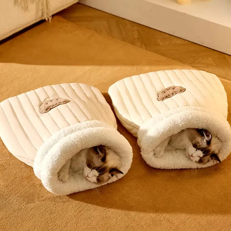 Fleece cat sleeping bag nest in light brown colour with a 3D entrance, shown on a wooden floor.