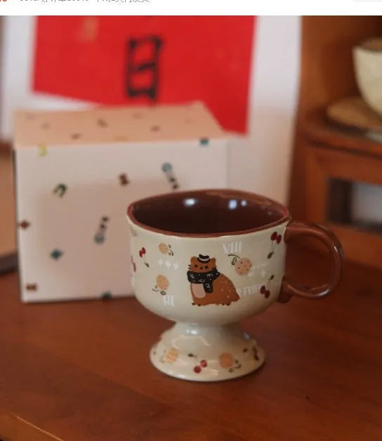 Antique caramel ceramic goblet with saucer featuring a beaming cat cartoon pattern in Autumn Squirrel colour, 250ml capacity