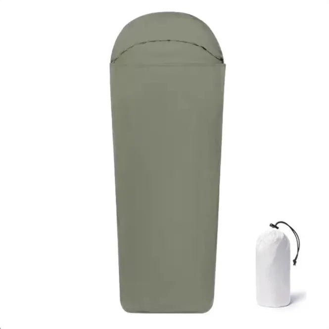 Blue mummy-style camping sleeping bag with tapered design on a green background.