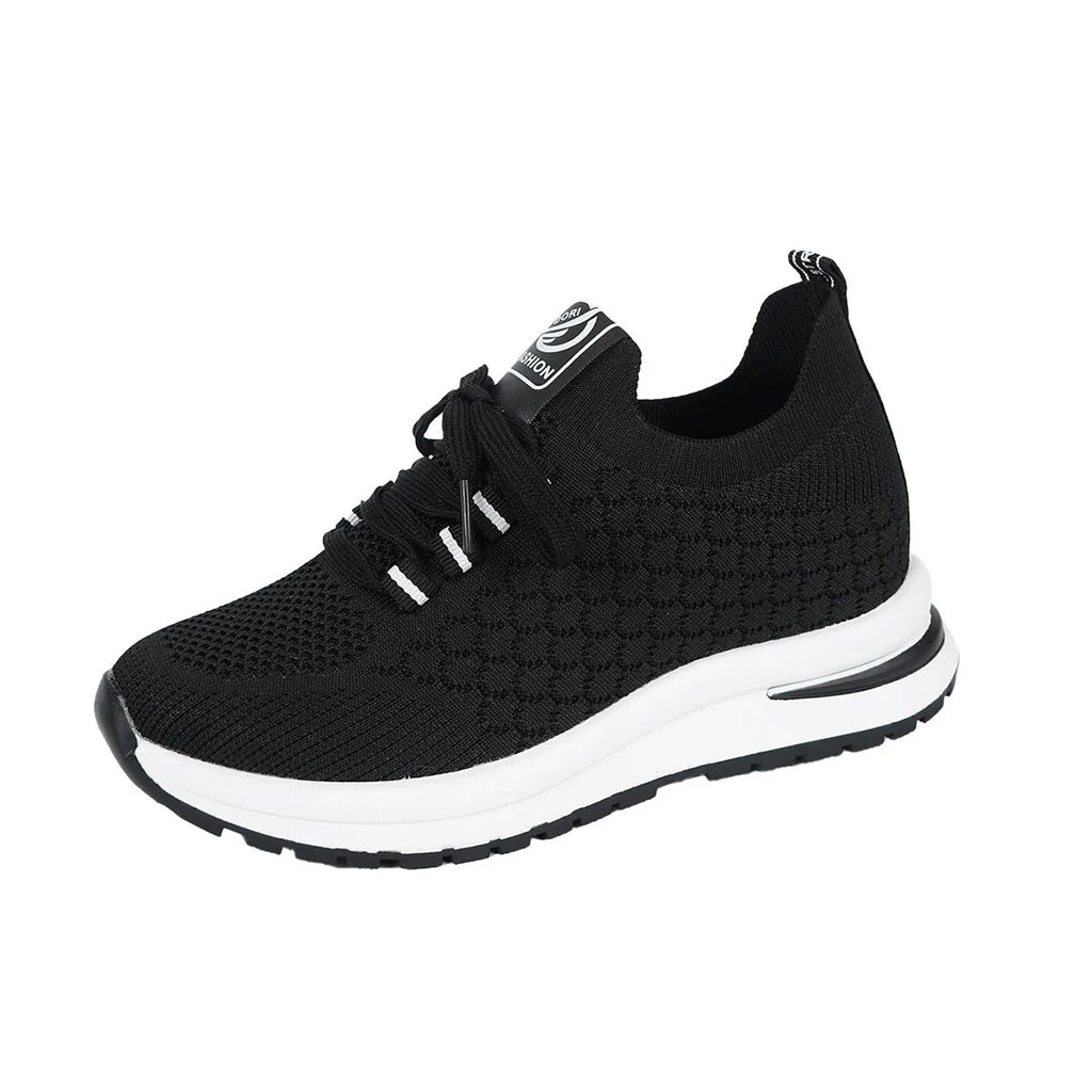 Women's black and white mesh platform sneakers with flat sole and lace-up front.