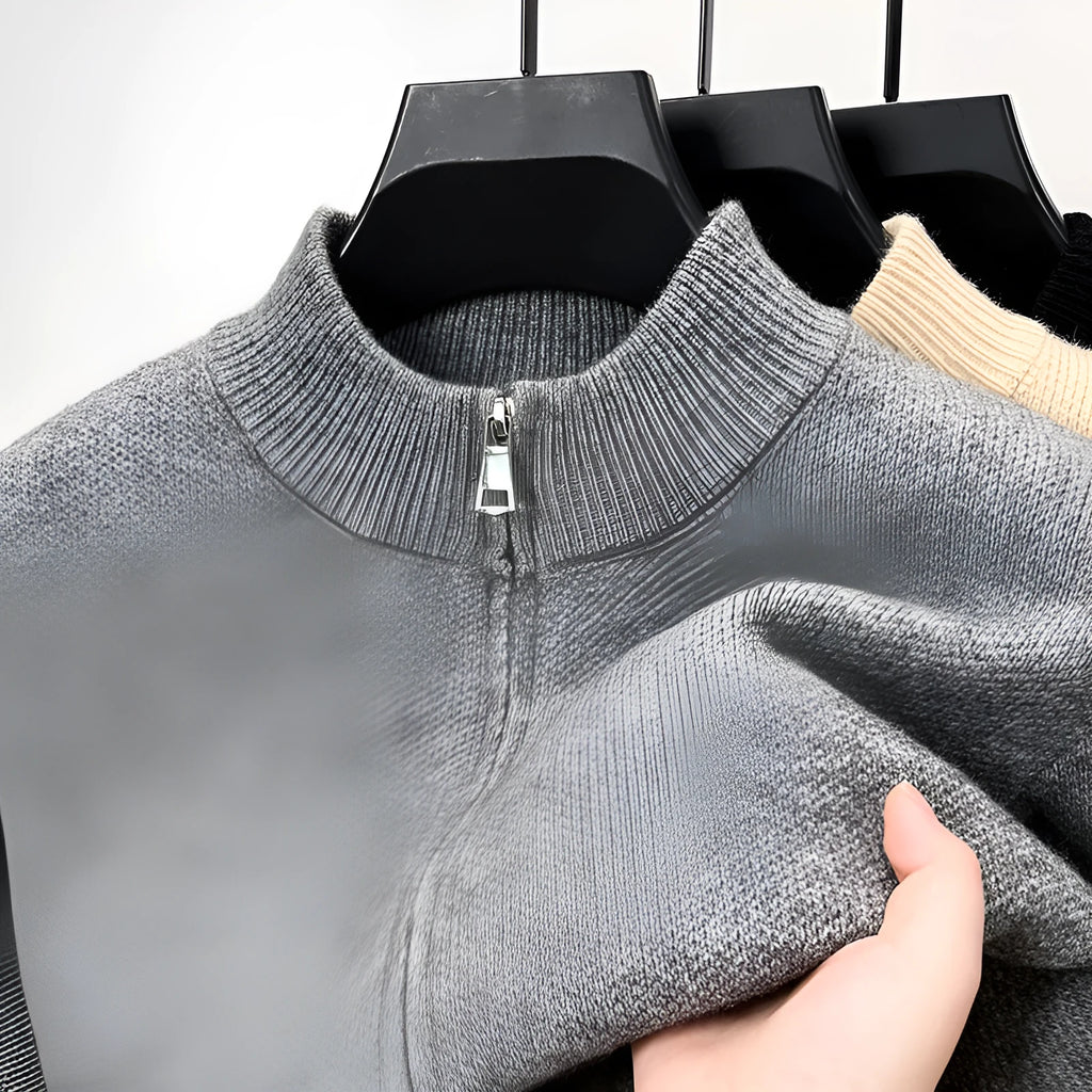 Men's black knitted zip-up cardigan with a stand collar, shown in a loose fit.