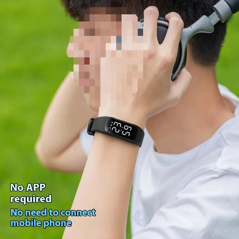 Smart vibration alarm watch with LED display and coloured silicone strap on a wrist