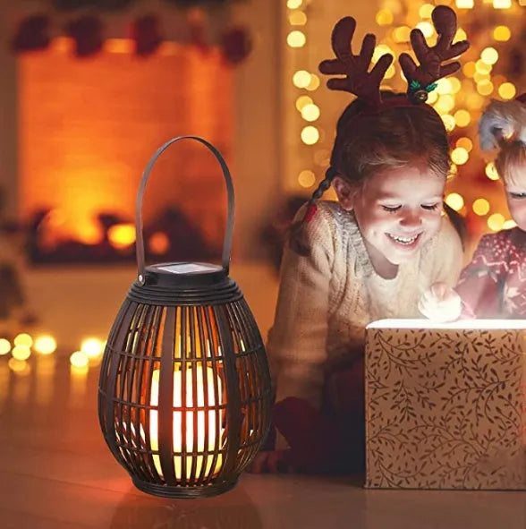 Oval rattan-style solar garden light in retro design for outdoor patio use.