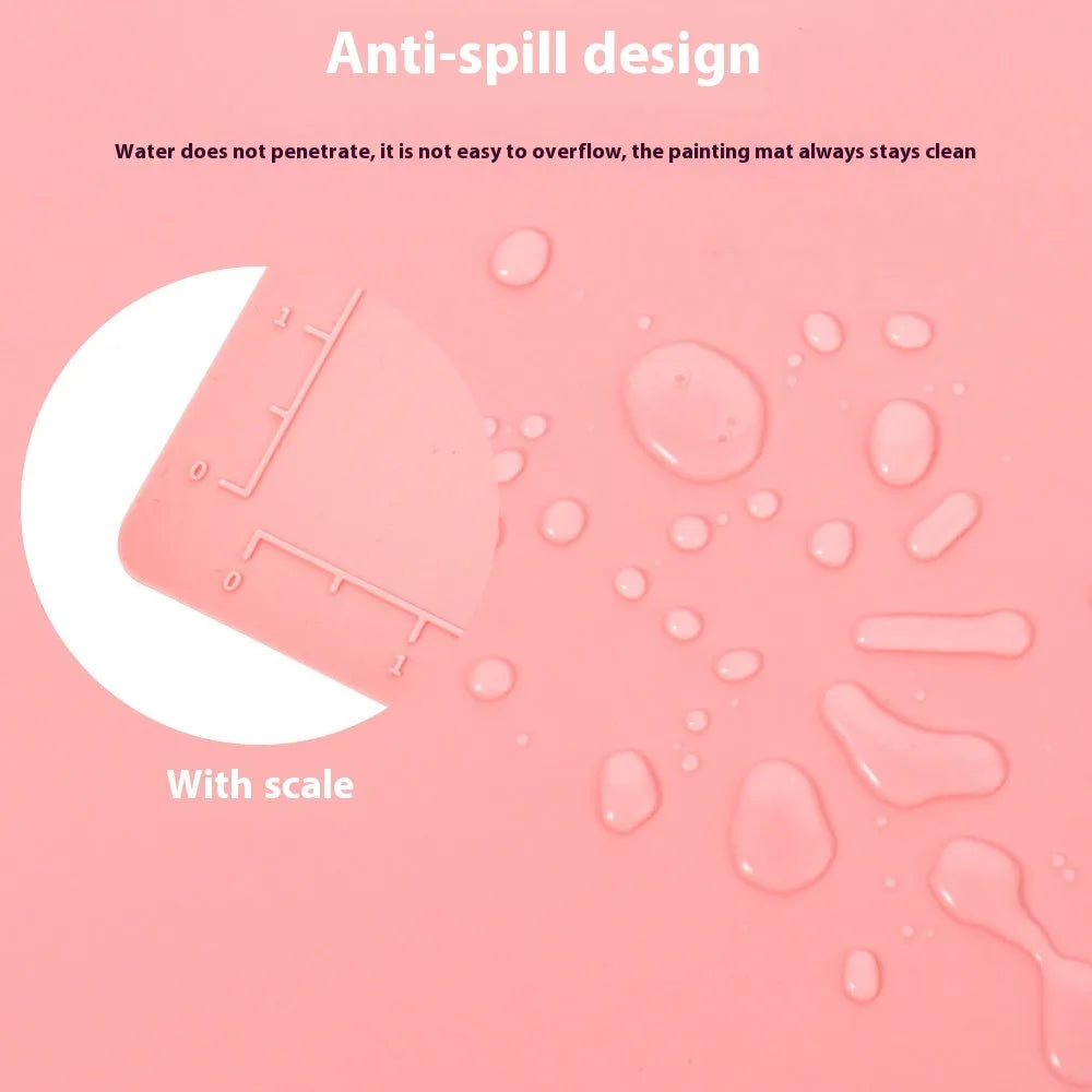Light blue silicone painting mat measuring 50 by 40 cm on a wooden table