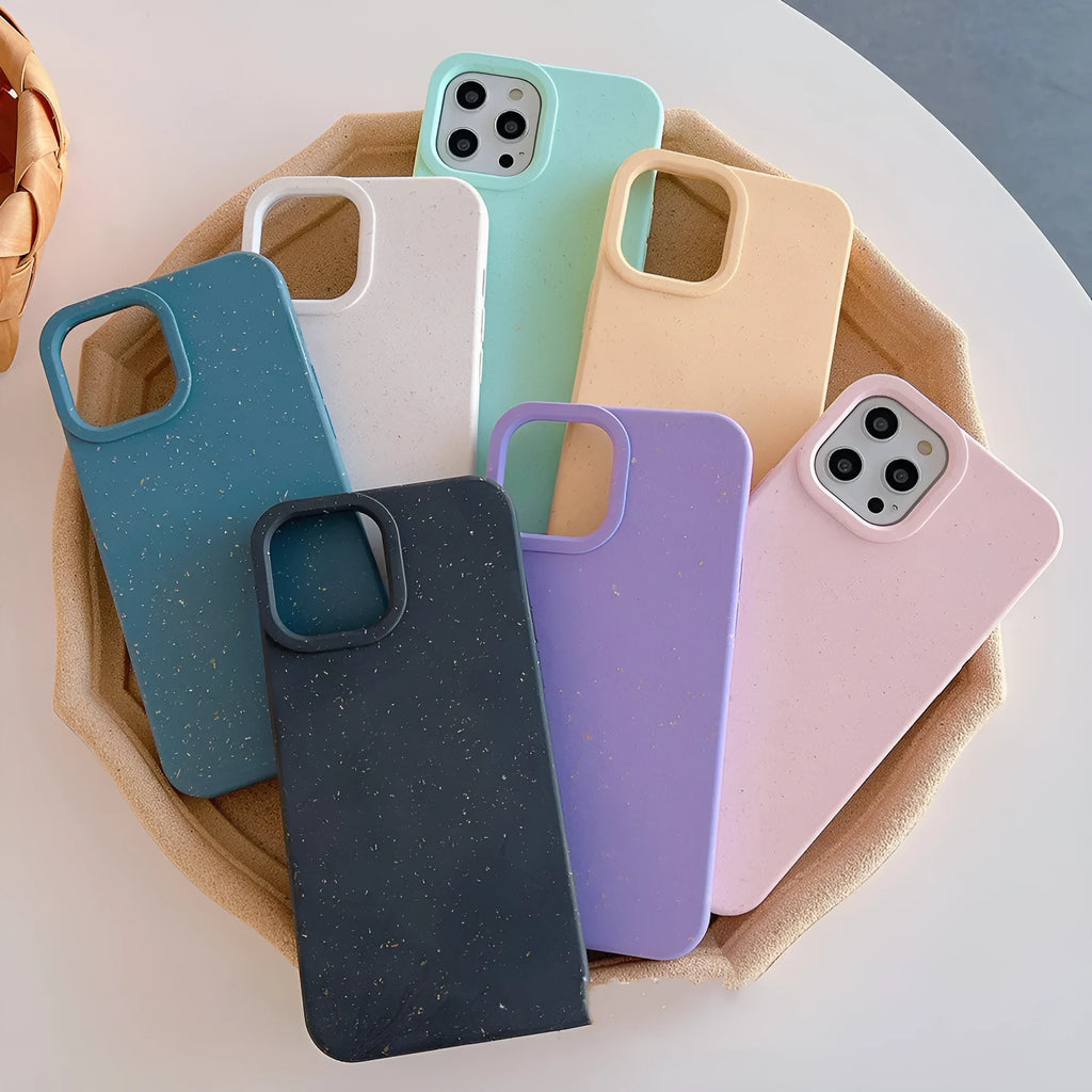 A degradable wheat straw phone case for iPhone on a wooden surface, showing its rear cover design.
