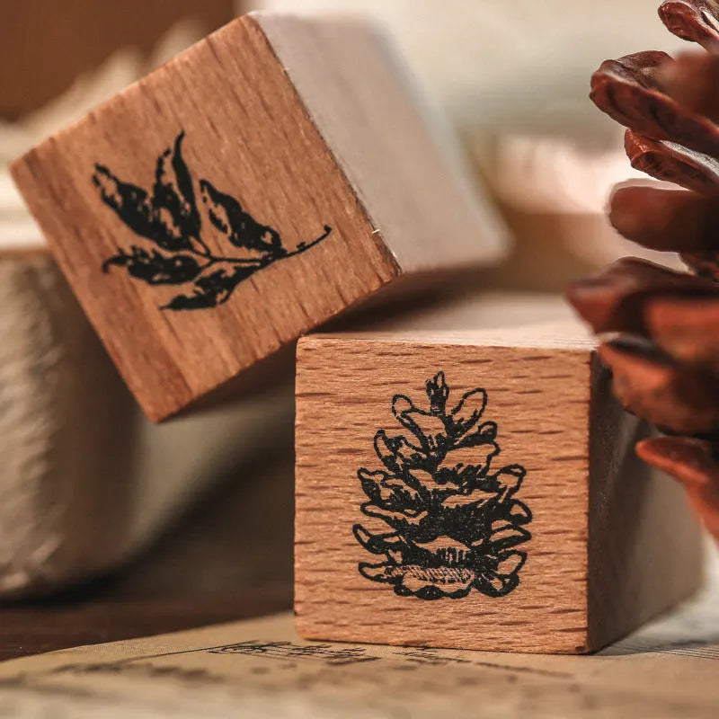 Mr Paper Seal Suit wooden stamp set showing seven stamps in either stars and moon or botanical designs on a craft table.