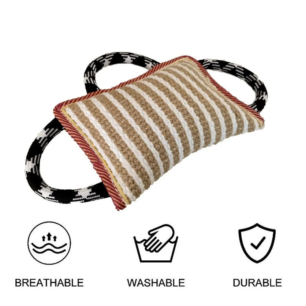 Jute dog tug toy with three rope handles and a central bite pillow, shown in assorted colours.