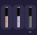 Wireless straightening and curling comb in rose gold colour with multiple international power plug adaptors.
