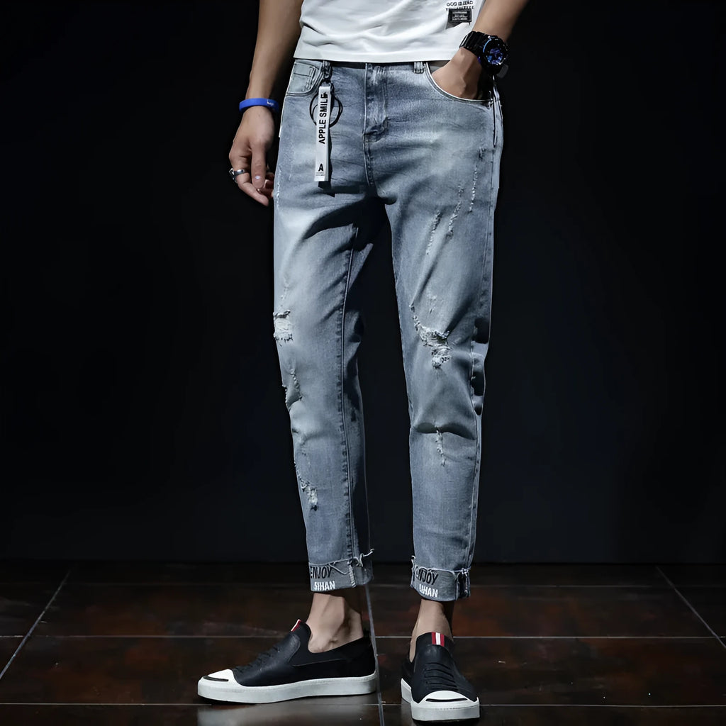 Light blue ripped jeans with straight leg, mid waist, and cropped length for youth