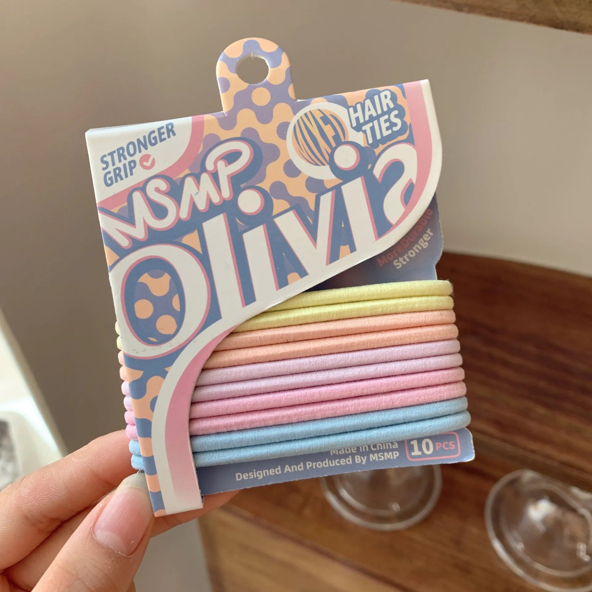 Candy colour elastic hair bands with braided design stretched to show length