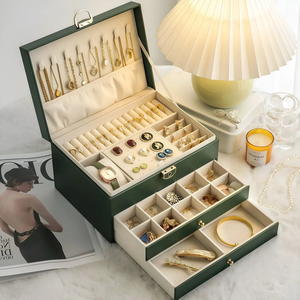 Leather jewellery box with three drawers open, showing storage for necklaces, earrings and bracelets.